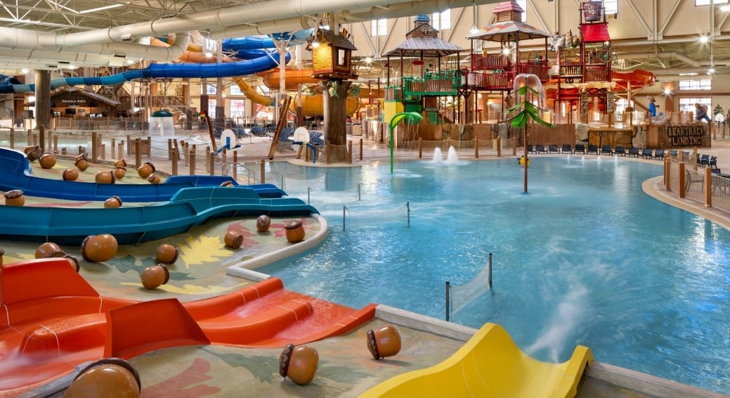 Indoor waterpark with slides, pools, and play structures.