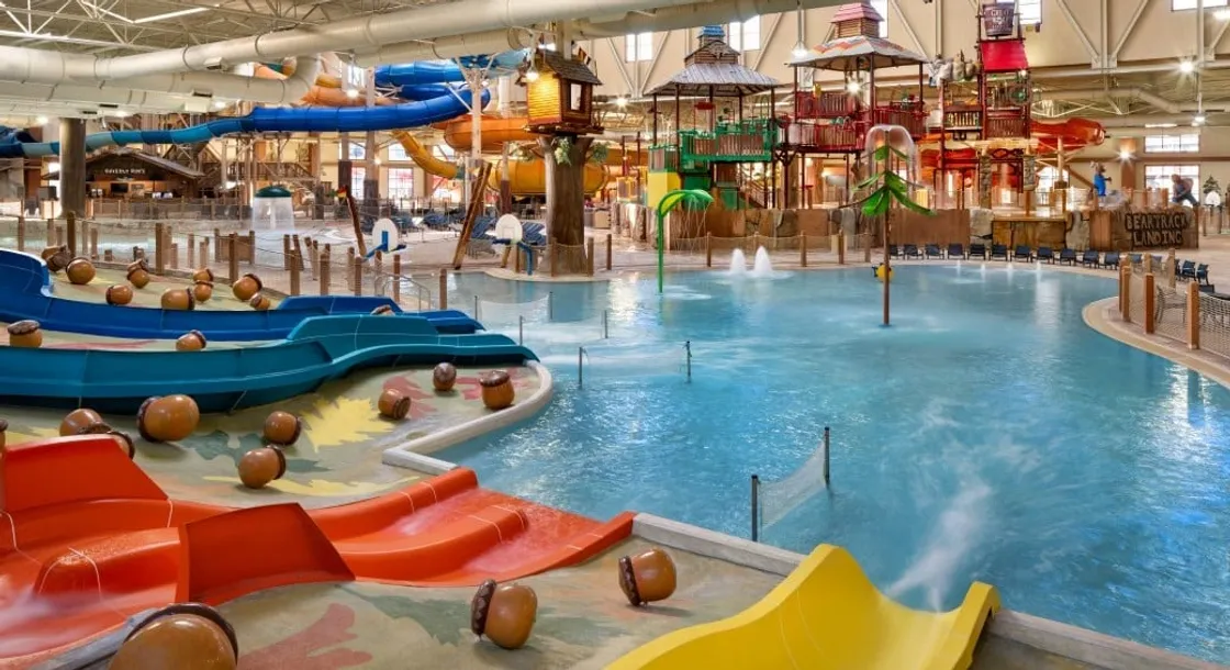 Indoor waterpark with slides, pools, and play structures.
